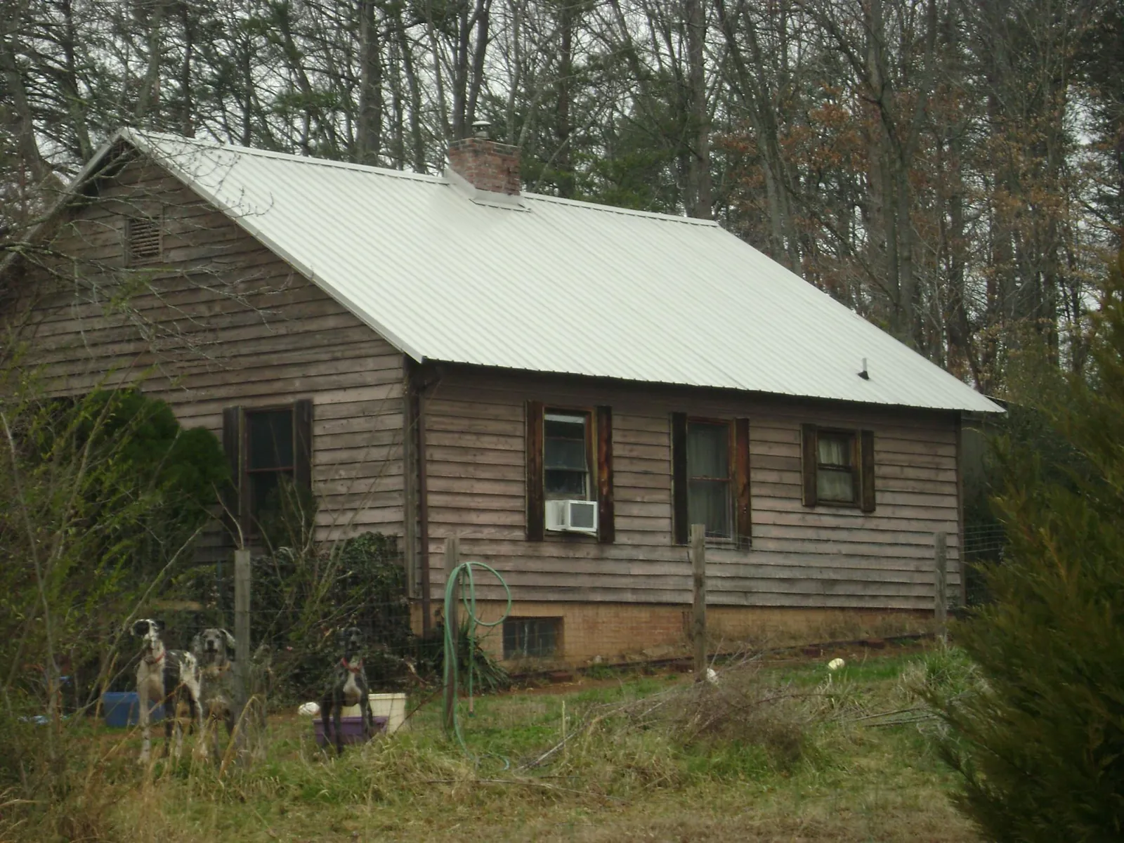White metal roof on an old wood sided farmhouse, from a Metal Roof Installation job in Salyer